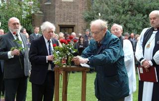 Brothers of the Charterhouse, John Guttridge, Charles Brown and Bernard Babloulene, place roses into a Tyburn Tree to commemorate the martyrs